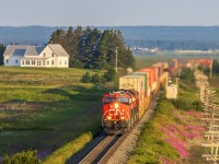Train Q120 hustles eastbound, as they cross the New Brunswick border into Nova Scotia. Shot at Fort Lawrence, Nova Scotia, Fort Beausejour, on the New Brunswick side, is out of frame on the right hand side. 