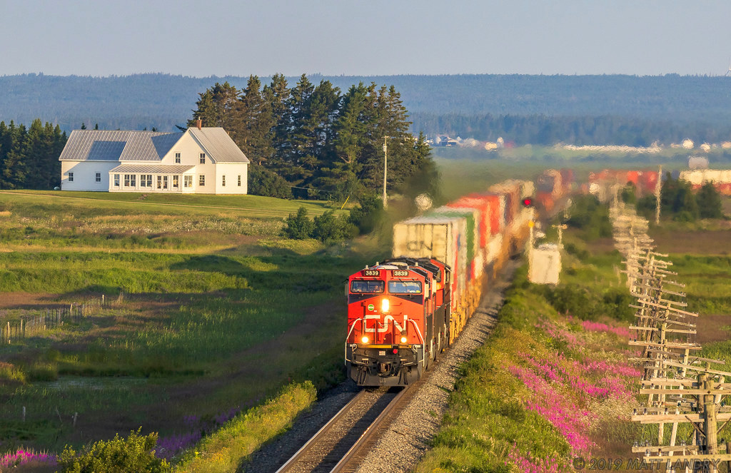 Train Q120 hustles eastbound, as they cross the New Brunswick border into Nova Scotia. Shot at Fort Lawrence, Nova Scotia, Fort Beausejour, on the New Brunswick side, is out of frame on the right hand side.