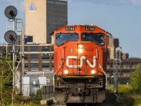 With a wave from Big J, train 407 heads by the VIA Rail station, passing the CN Moncton sign, while a sliver of sun decided to peek down onto the head end, just in time. 