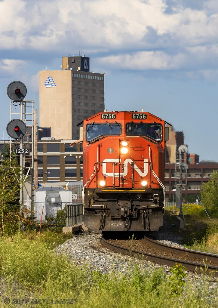 With a wave from Big J, train 407 heads by the VIA Rail station, passing the CN Moncton sign, while a sliver of sun decided to peek down onto the head end, just in time.