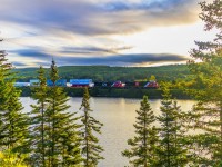 During a beautiful sunrise, stack train Q120 heads through the scenic Folly Lake, Nova Scotia. 