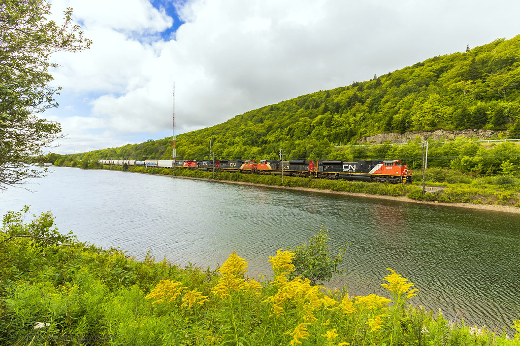 In a great scenic spot, train 407 heads through Folly Lake, Nova Scotia with 5 engines on the point.