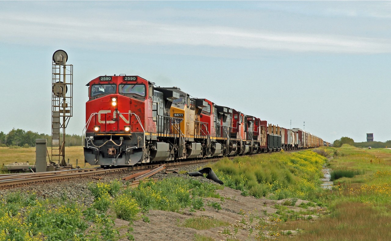 A mixed array of power on this eastbound entering the siding at Russett.  Dash 9-44CW CN 2590 is in the lead followed by AC4400CW UP 6611, Dash 9-44CW CN 2573, Dash 8-40CW CN 2099, SD75I CN 5676 and in the rear Dash 8-40CW CN 2166.