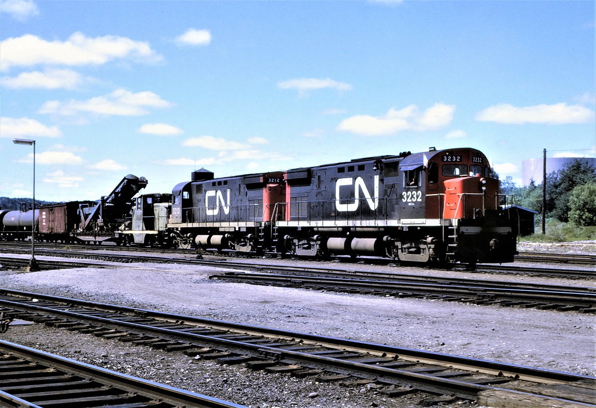 CN train 474 heads out of the yard at Capreol, Ontario on a pleasant afternoon in June 1969.  Behind C424s 3232 and 3212 is ex CN 44 tonner #5, now Stelco #5.  The first car of the train is an interesting high and wide load followed by an old wood ice reefer.  Oh how I wish I had taken a picture of that car.