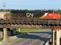 The 2837 is bringing up the rear of the oil train empties as it passes over the east leg of the wye at Bretville Jct. It's destination of Kinder Morgan is only a couple of miles south down the Camrose Sub. The main subject is the bridge span being passed over. It still sports an old CN logo (with "courtesy and service") and the clearance is reported in feet and inches. Myself, I can remember seeing this span back in the seventies when coming home from Ft. Sask. Reading on the CNRHA website, which has some photos and info on this and other bridges like this one, it can probably be safe to say this span has been here since the early sixties (before the change to the CN noodle era). As can be seen, the other spans have been changed on the west bound lane of the Yellowhead Hwy. How much longer till this one needs replacing? I love the wooden fence along the side.