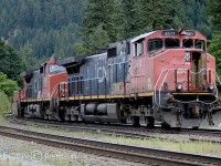 CN 2511 with the 2620 trailing are westbound, and stopped at Boston Bar East, awaiting a crew change before switching over to CN's Yale Sub. Chaumox Road crosses the tracks here and leads down an embankment, where it crosses the Fraser River, and into the village North Bend and CP's North Bend yard.