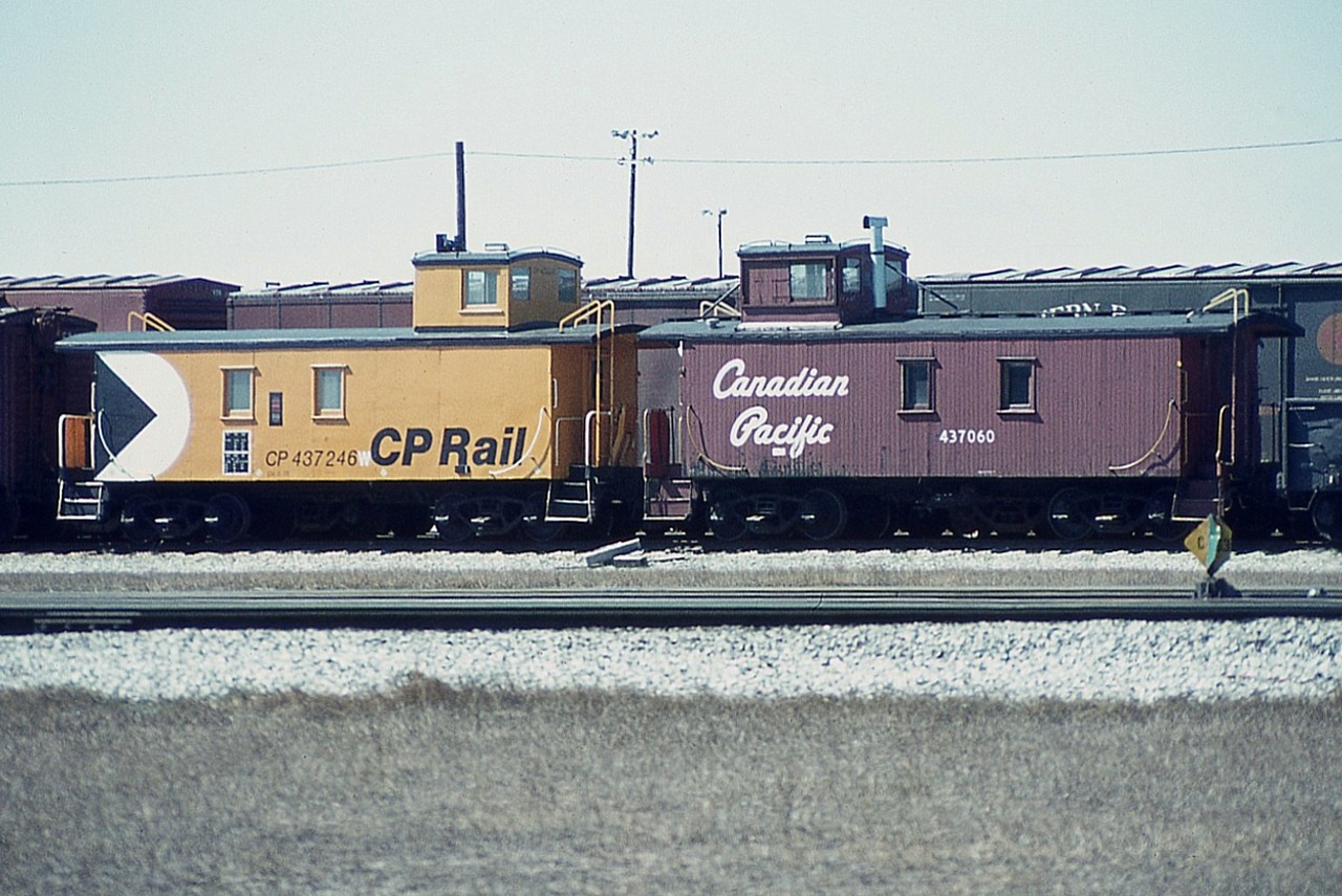 Interesting view comparing paint schemes on a couple of old CP cabeese from 40+ years ago. (Note Northern Pacific boxcar in behind!)