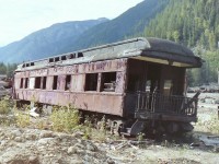 Having seen this car many times while driving on the TCH. It sat on the south side of the highway just west of Revelstoke BC. I'm glad I took this nice sunny day to actually stop and have a closer look at it. I knew it was private property and I tried to find someone working on site but it was to no avail so I slowly worked my way down to the car,took some pictures and left the site.

Later I was told that the car started out as a CNR car & was later perchasd by the CPR. If I am correct the car has been saved and now resides at "Three Valley Gap" resort and is painted back to it's CNR colors.

As for the GPS location! So much has changed since then that I could not find the site, but I did try.