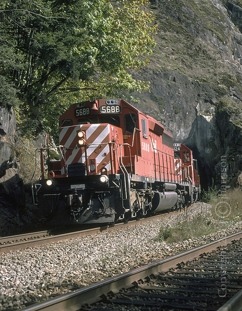 CPXW 5688 with the GP38-2 3124 trailing, roll out of the westward track portal at Agassiz. A similar submission I took on the same day listed this location as Magellan, which would be correct as of 1998. The 5688, I'm quite sure, was scrapped in or around 2009.
