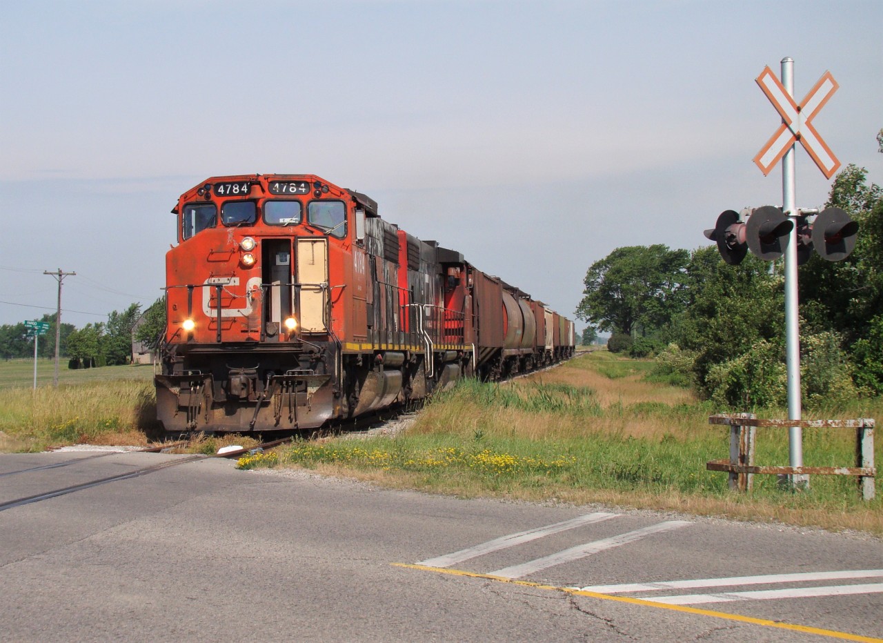 CN 4784 and 4785 lead a 10 car local to Blenheim seen here crossing Middle Line just outside of town.