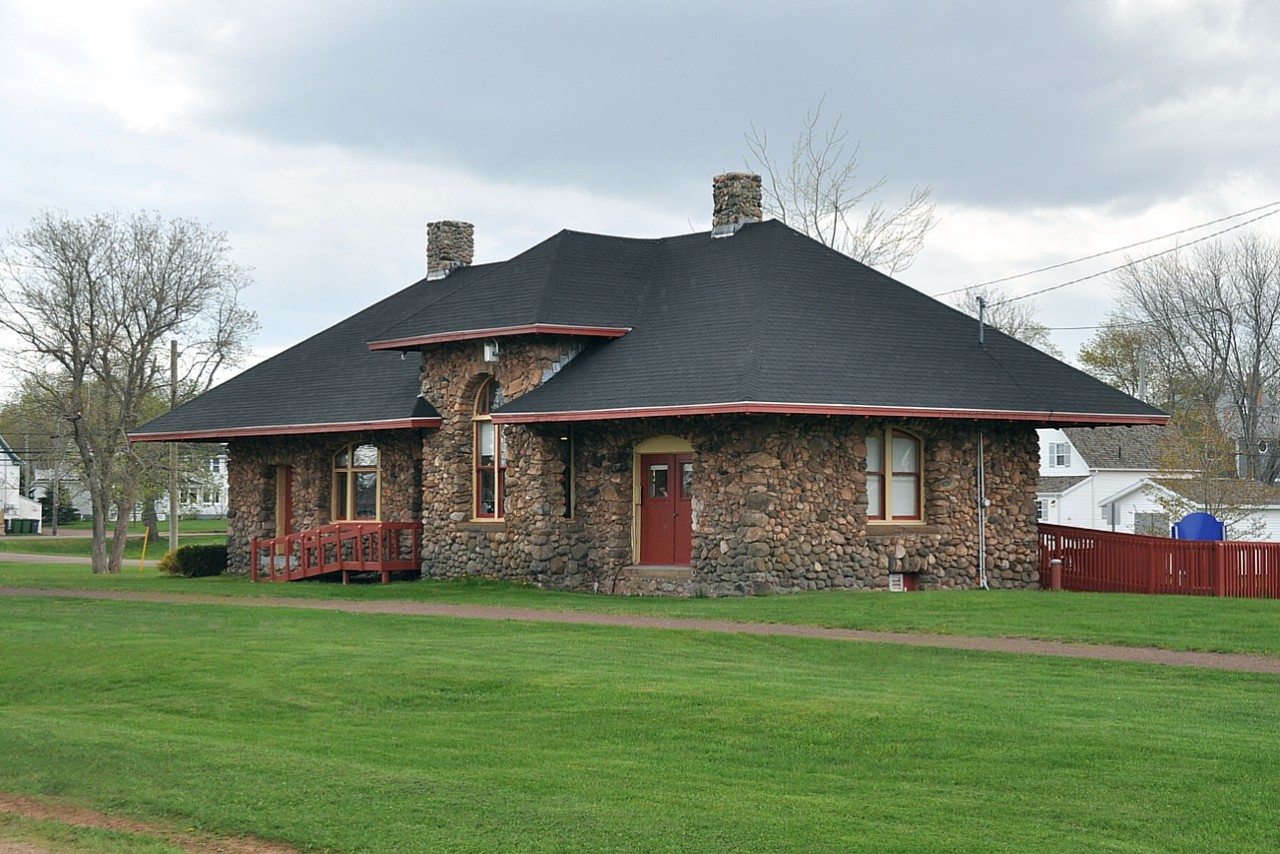 The rather fancy former station at Alberton is one of only two stone stations built on Prince Edward Island. (The other is Kensington) Built in 1904, its outer walls were constructed with granite stones left by glaciers, as found in local farm fields. The builder was J.M. Clarke of Summerside. There was once a wye here, a spur ran down to Northport Wharf on Cascumpec Bay on the Gulf of St. Lawrence. As a result Alberton was considered a 'terminal' station, one of six on the Island. This meant at one time there was the passenger house,an engine shed and a car shed. But those other facilities are long gone, as is the spur, pulled up way back in 1927. This is a beautiful structure, and now serves as the local library.