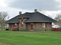 The rather fancy former station at Alberton is one of only two stone stations built on Prince Edward Island. (The other is Kensington) Built in 1904, its outer walls were constructed with granite stones left by glaciers, as found in local farm fields. The builder was J.M. Clarke of Summerside. There was once a wye here, a spur ran down to Northport Wharf on Cascumpec Bay on the Gulf of St. Lawrence. As a result Alberton was considered a 'terminal' station, one of six on the Island. This meant at one time there was the passenger house,an engine shed and a car shed. But those other facilities are long gone, as is the spur, pulled up way back in 1927. This is a beautiful structure, and now serves as the local library.
