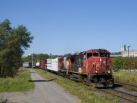Faded units CN 2508 & CN 9524 lead a 57-car train CN 324 around a curve in the St-Henri neighbourhood of Montreal.
