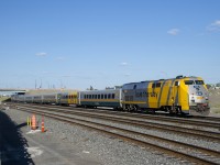 VIA Rail's newest slogan ('love the way') is on the long hood of VIA 909 as it pushes VIA 64 eastwards.