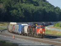 Grinding along at 15 mph or less (as it is running as a transfer and does not have a Train Information Braking System on the rear), CN 527 rounds a curve on the freight track of CN's Montreal Sub with CN 2855 & CN 2859 for power. This portion of the Montreal Sub has only been in regular service a bit under a year at this point.