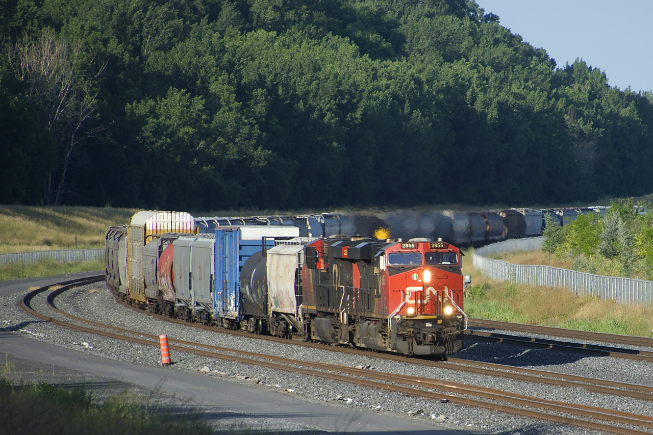 Grinding along at 15 mph or less (as it is running as a transfer and does not have a Train Information Braking System on the rear), CN 527 rounds a curve on the freight track of CN's Montreal Sub with CN 2855 & CN 2859 for power. This portion of the Montreal Sub has only been in regular service a bit under a year at this point.