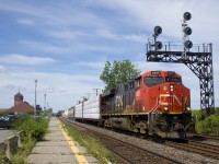 CN 368 has CN 2951 up front and CN 2958 mid-train as it heads past the Dorval Station with 154 cars.