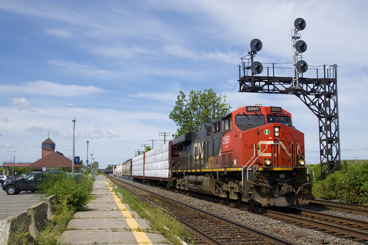 CN 368 has CN 2951 up front and CN 2958 mid-train as it heads past the Dorval Station with 154 cars.