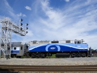AMT 1348 leads EXO 60 under a signal gantry after making its stop at Dorval Station. In the foreground is CN's Montreal Sub.