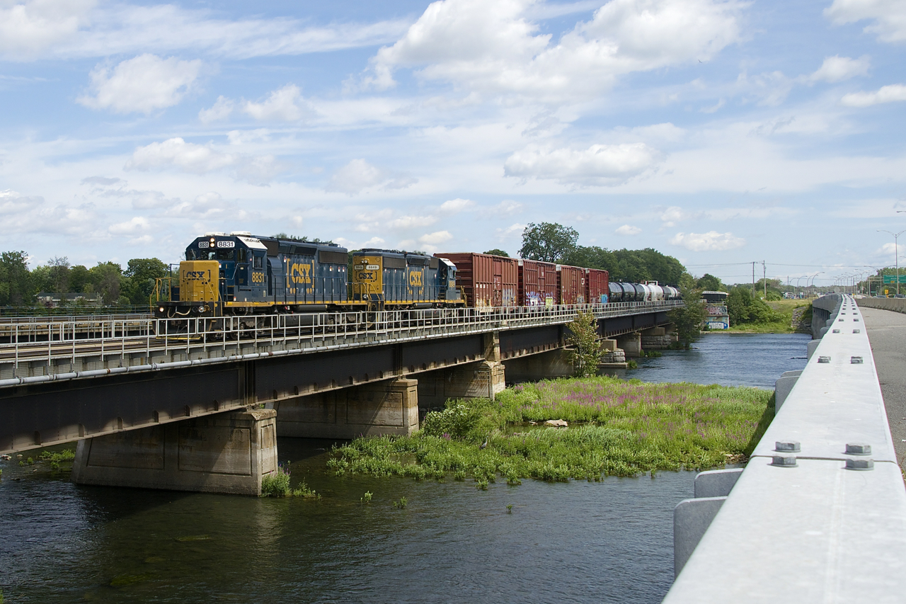 It has been announced today that CN is buying CSX's ex-NYC Montreal Secondary line (running from Valleyfield, Qc to near Syracuse, NY), which will soon put an end to runthrough CSX power in and near Montreal. Always a nice diversion from the usual CN and CP power, here we see CN 327 with a pair of ex-Conrail SD40-2's (CSXT 8831 & CSXT 8849) crossing the Ottawa River. This train will reach CSX rails at Valleyfield and get a CSX crew near the border.