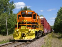 The westbound turn on the Lachute Sub has a larger than normal train (45 cars) and QGRY 2004 for power as it approaches the Montée Hall crossing.