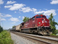 CP 650 with CP 8034 up front and CP 8125 on the tail end approaches the Du Canal station on a sunny afternoon.