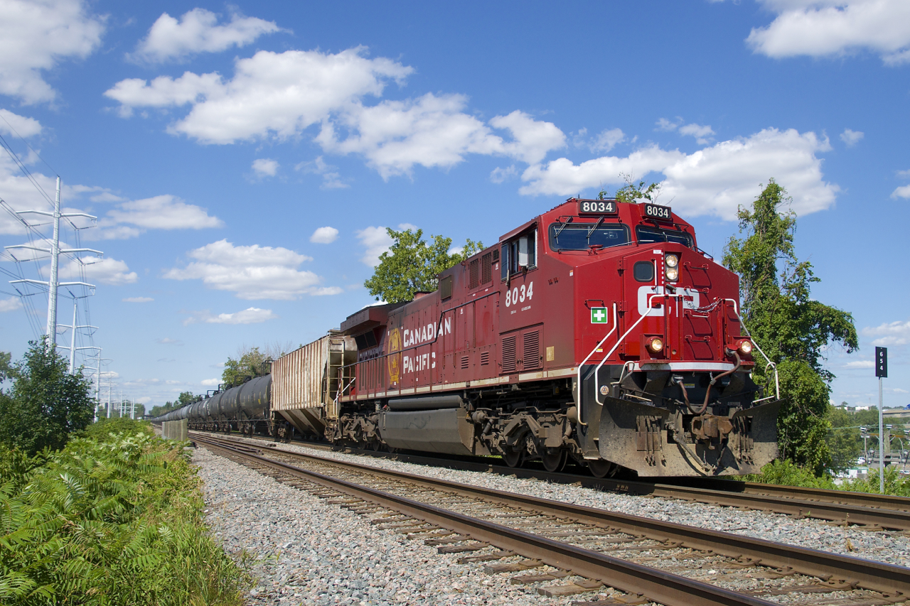 CP 650 with CP 8034 up front and CP 8125 on the tail end approaches the Du Canal station on a sunny afternoon.