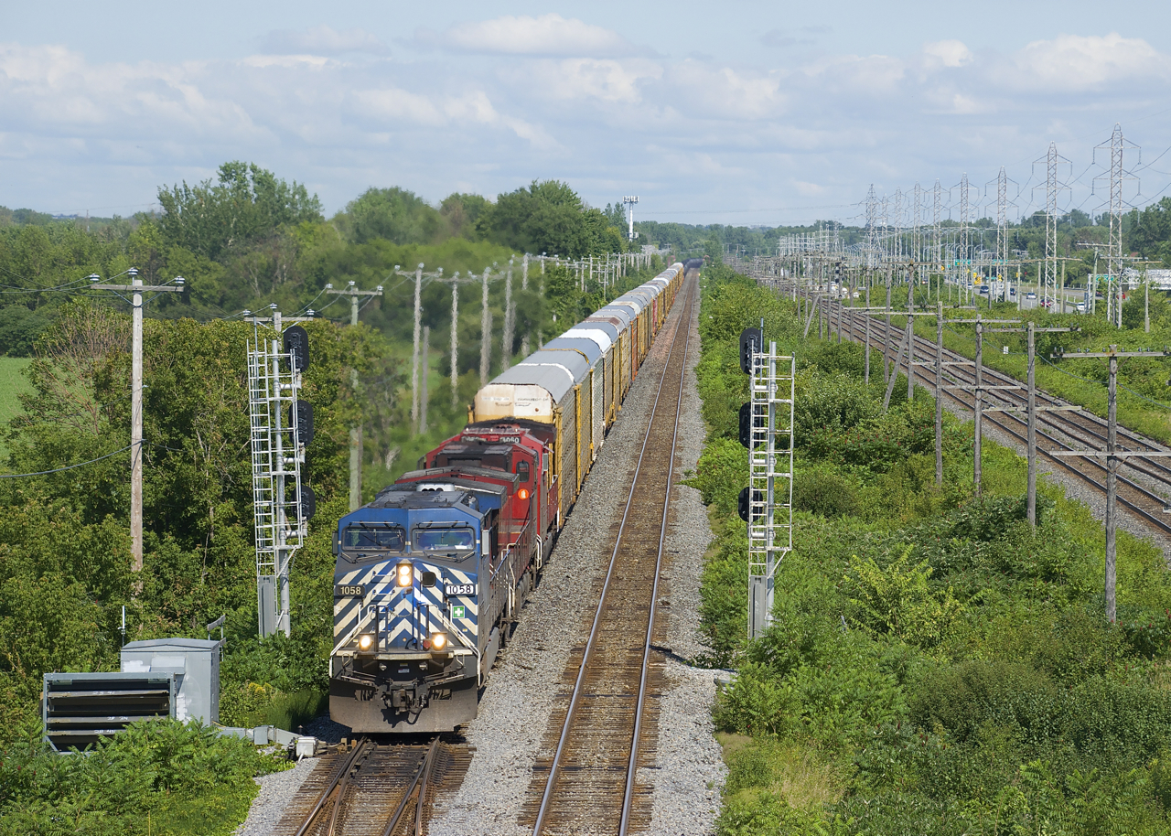 Empty ethanol train CP 651 has a ut of 49 autoracks up front (and 94 tank cars behind) as it splits a set of signals on CP's Vaudreuil Sub just before it leaves the island of Montreal. Power is CEFX 1058, CP 9732 & CP 8060.