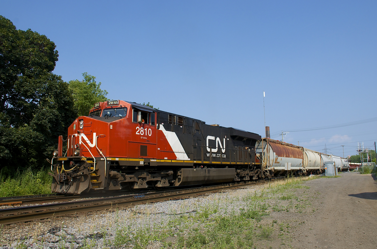 CN 527 with a single ES44AC for power (CN 2810) is backing up as it does its lift and set-off at Pointe St-Charles Yard. It is crossing over from the north to the south track.