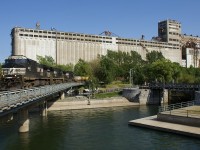 Operating as CN 596, NS power (NS 9419, NS 4028 & NS 9521) is bringing CN X148 into the Port of Montreal after the train spent most of the day parked on CN's Montreal Sub. Behind the train is the massive but out of use grain elevator #5.