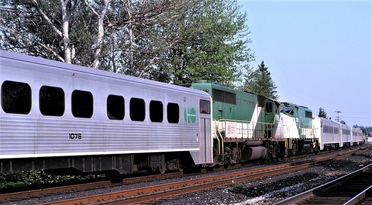 During the very early days of GO Transit service to Richmond Hill, ON, the first two trains from Toronto each afternoon (985 and 987) were combined for their return trip to Toronto as train 986.  Shown here, the trains have been combined and are waiting to depart south.  Note that the set of equipment farthest from the camera consists of four of the original self propelled cars with a locomotive at each end.  The motors on these cars were running only to provide lights and air conditioning as the two locomotives were not equipped with head end power.