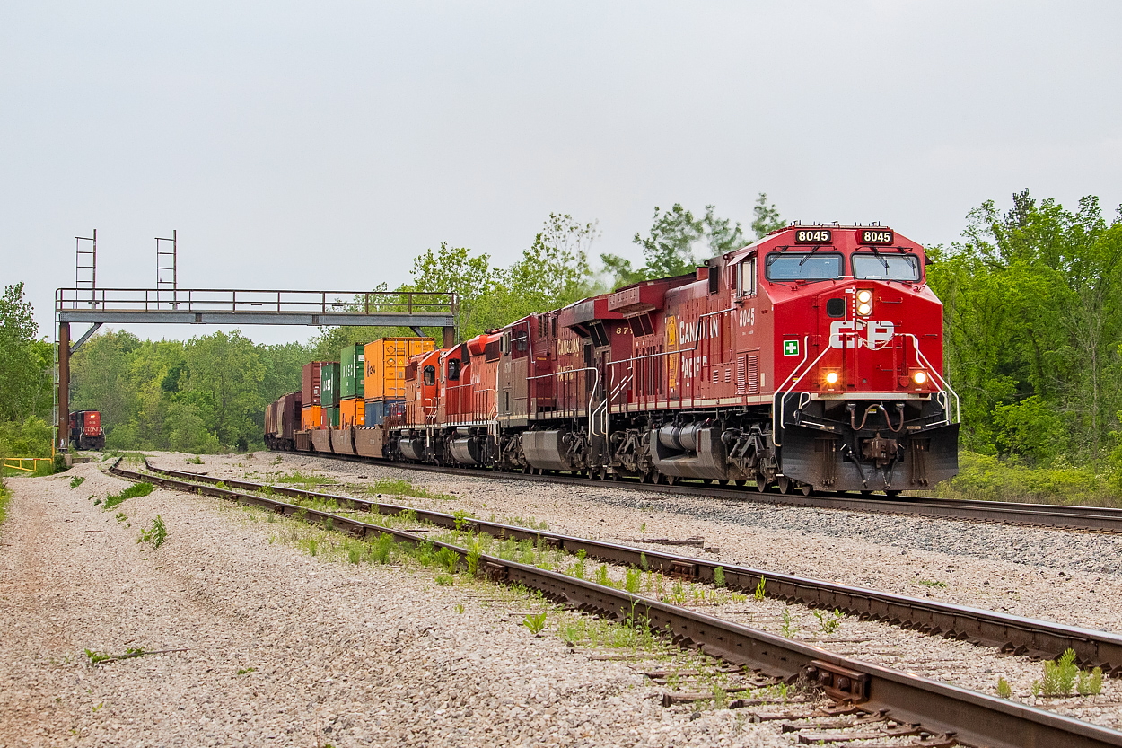 CP 254, powered by 8045 and 8710 with SD40-2s 6020 and 6005 DIT, has just departed Welland for Buffalo, heading under the defunct signal bridge at Feeder. In the background, CN L562 with the 5615 solo continues to work Trillium's Feeder Yard, after bringing over a larger transfer in excess of 50 cars.