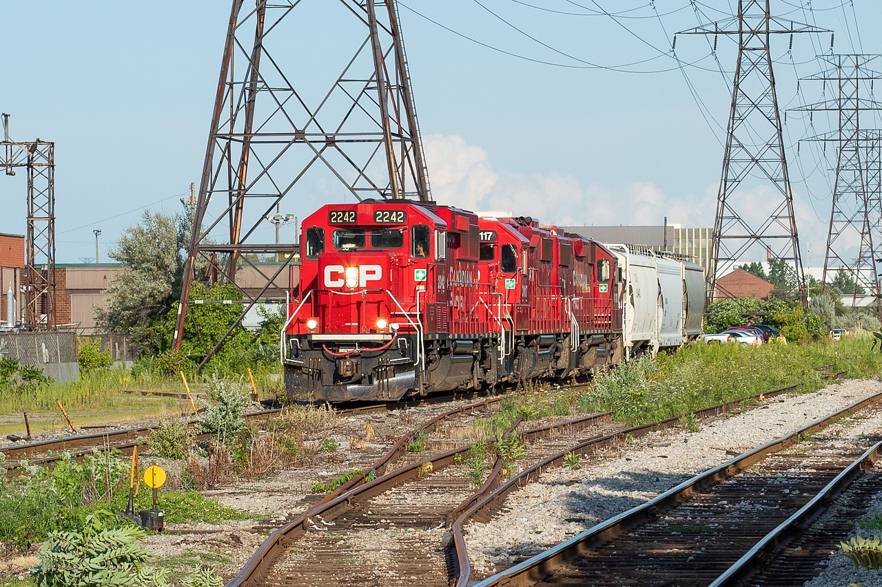 After setting off some cars at Adams Yard, CP TH21 headed back westward down the Beach Branch towards the Belt Line, from where they shoved back across Gage Ave and Birmingham Street, and then went across the diamond at Irondale and up into Bell & MacKenzie - the destination for the three hoppers. The track in the foreground is CN's N&NW Spur, and the two tracks in between are for interchange traffic. I posted a shot of CN here back in January, lifting cars from the interchange. CN seems to be using this area for car storage now too, as a cut of covered Illinois Central gons have been sitting in the area for two or three months now.