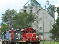 Having completed switching at the Cargill facility at Sarnia's harbour, CN 7046 and a pair of GTW units pull out of the grain and fertilizer handling complex with roughly a dozen CSX covered hoppers.