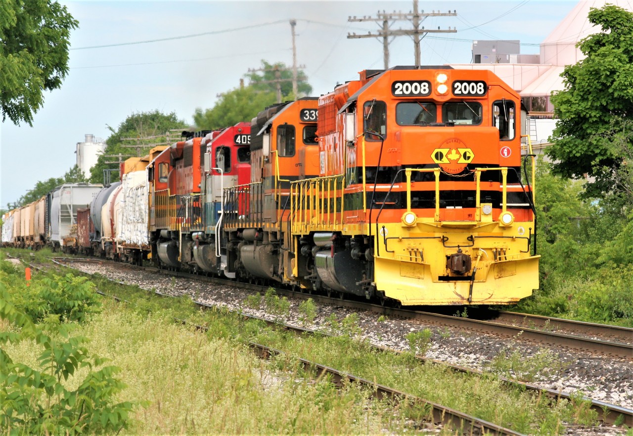 Goderich-Exeter Railway (GEXR) train 431 with QGRY GP38-2 2008, GEXR SD40-2 3394, RLK GP40 4095 and RLHH SD40-2 3403 is seen approaching the St. Leger Street crossing in Kitchener, Ontario on June 19, 2018.