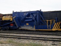 Ontario Northland 528, a Jordan spreader, is pictured stored at Cochrane between two boxcars. According to the Canadian Trackside Guide, it was built by the O.F. Jordan Company in 1945 as a Type A spreader, serial number 795. Jordan spreaders are handy for both plowing sidings and yards during the snowier seasons, and spreading ballast and cutting ditches during the warmer months.