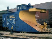 Ontario Northland Railway snowplow 555 is pictured stored awaiting the next winter snowplowing season at North Bay, in October of 2000. It was originally built for the ONR by Canadian Car & Foundry in December 1923. Modern features such as a dual sealed-beam headlight and upgraded front windows mingle with older features like the stem-winder brake wheel and solid-bearing journal trucks.