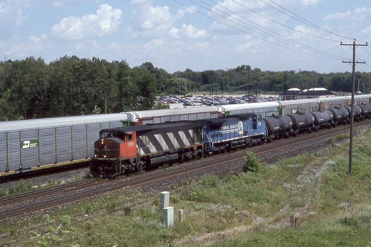 CN No. 2106 was constructed by BBD in early 1982. The burly unit is shown leading Conrail C40-8W No. 6126 past a solid string of autoracks, most likely staged for the nearby Ford Oakville plant. Unlike the EMD F/FP45 units from the mid 1960’s, the reincarnated cowl structure was more than cosmetic. Fitted with access doors, routine maintenance was entirely feasible. No. 2106 was among the longer serving HR-616’s and would depart the roster as part of a sale of several sister units to National Railway Equipment (NRE). A number of the HR-616’s would linger in storage for years at the NRE facility in Silvis, IL.