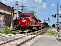 A fine and sunny afternoon in July finds CP ac4400CW 8117 leading a decent sized train 420 manifest through the major city of Toronto as they make their way westward out of the CPR yard and towards the Galt Sub and eventually the USA. Train is about to cross the Bartlett ave downtown crossing and the factory-like building which they are going right by on the left is none other than a typical downtown restaurant/bar, but with the rather unique name known as ‘Blood Brothers Brewing’! I gotta check that place out sometime!! Hopefully will remember to do so on my next visit to the North Toronto Sub! Timing is 14:51