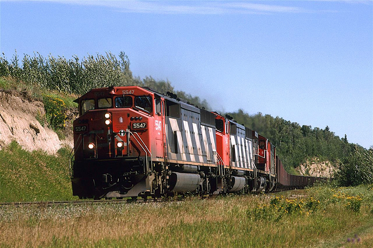 The one coal train that goes east out of Coal Valley is this one (Actually returning empty here). It ran to Thunder Bay, where I presume the coal was transloaded to Lakers and then to Ontario Hydro coal-fueled generating plants.
The train is very likely travelling over a bed or two of coal that is strip mined just a few hundred meters beyond the train. The quality of this local coal pales in comparison to the material that the train transports.