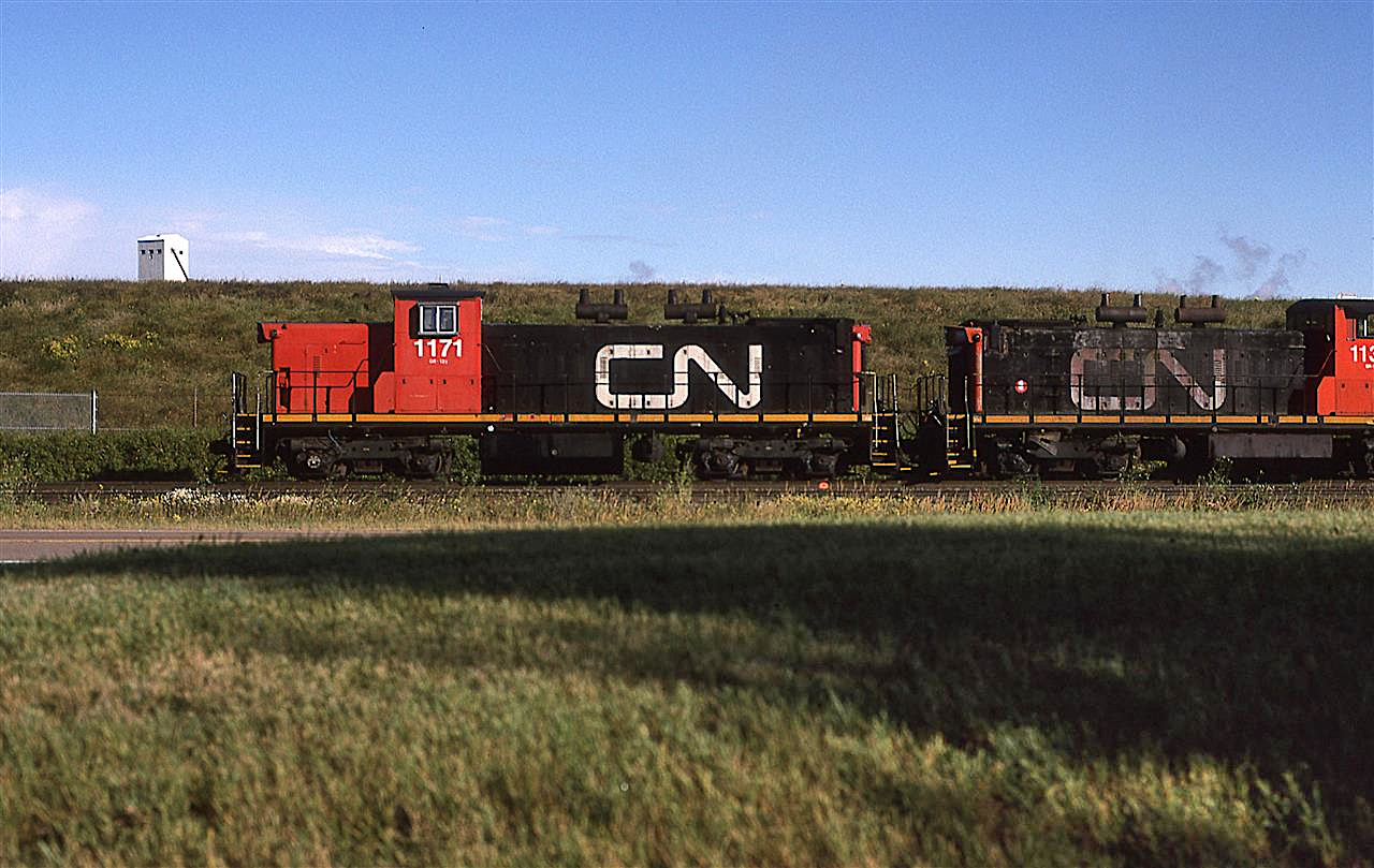 This is either a "Day in North America or West" shot. The relatively unique GMD-1's were either loved or hated - personally, I liked them.
They are pictured here by the Celanese plant, although it is hidden mostly by the earthen berm.