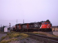 This is another fading light shot that taxed the film and scanner.
526 is coming into Edmonton, from Scotford Yard in Fort Saskatchewan and is on the east leg of the wye of the Vegreville sub as it joins the Wainwright Sub as East Junction. It brings in many chemical cars that are destined for points east, therefore, it goes to Clover Bar Yard on the east side of town. I think that from there, it might switch out some cars and then head east as a 200 train.
The beginning of the bridge at right is to cross over the LRT tracks 