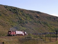 a westbound CP COFC, TOFC and doublestack container train is running through the Bow Valley between Calgary and Cochrane. At this time, it was a beautiful quiet walk in ranch and farm country. Now it is a Provincial Park, with walking and bike trails (and probably more fences. It was my favorite local place to go to shoot trains.
In spite of the much easier access, I have not seen that many photos taken in this area. I did one very recently, however. and learned that the hill in the background once hosted a sandstone quarry.