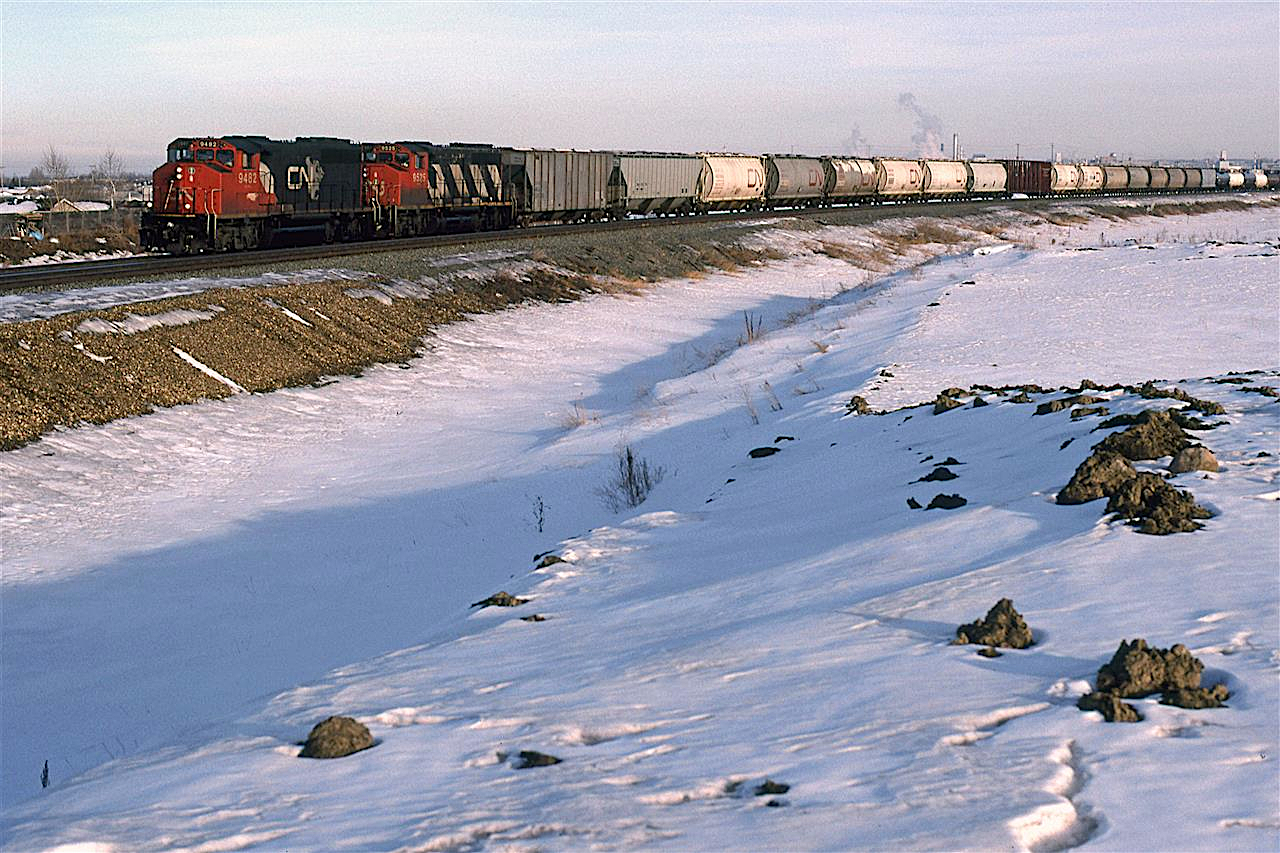 403 was another train heavy with chemical traffic. The hoppers on the front end may have been used to transport raw or finished materials for the Sherritt fertilizer plant just outside Fort Saskatchewan. It ran from Winnipeg to Edmonton.
The steam in the background is from the now-defunct Celenese plant by Brettville Junction.
