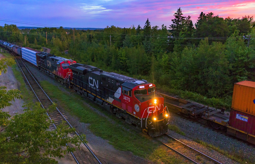 Running about 6-7 hours late, train 306 arrives at Gordon Yard at Moncton, New Brunswick at sunrise. CN 121 waits on the next track, and has the highball to leave once 306 pulls into the yard.