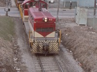 A photo from Ray Hoadley, taken at Beach Rd, Hamilton as TH&B 53 heads up the Belt Line with Industrial Brown Hoist TH&B X-766 in tow as well as a couple of other cars. Ray must have been standing on the embankment of the subway underpass of the CN Grimsby sub. There had been a derailment in the TH&B Adams Yard and the "big hook" had attended to the scene. In the image there is a bulk head flat loaded with cast iron pipes, one of the cars that had derailed.
I recall going through this spot numerous times when I worked for the TH&B. Beach Road was a nasty crossing and mid 1972 a transfer job was heading up the Belt Line and hit a truck at the crossing, killing the driver, some crew members receiving minor injuries and TH&B 56 more or less wedged in the subway overpass.