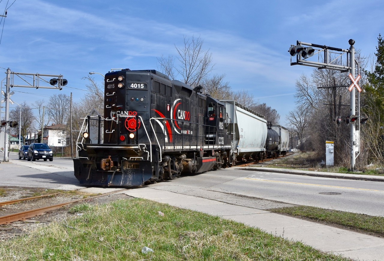 Having just crossed the bustling CN Halton moments ago and almost clear of bustling downtown Brampton, CCGX 4015 is seen carefully crossing over McMurchy ave southbound on this fine spring morning in April as they take 3 empties from Orangeville back to their owner, CP in Mississauga. Roughly 90min-2hrs later, 4015 will be seen returning northbound through downtown, only after having retrieved a handful of loaded freight cars from CP for delivery to the last 5-6 customers along this short line who rely on rail. Time is 09:52