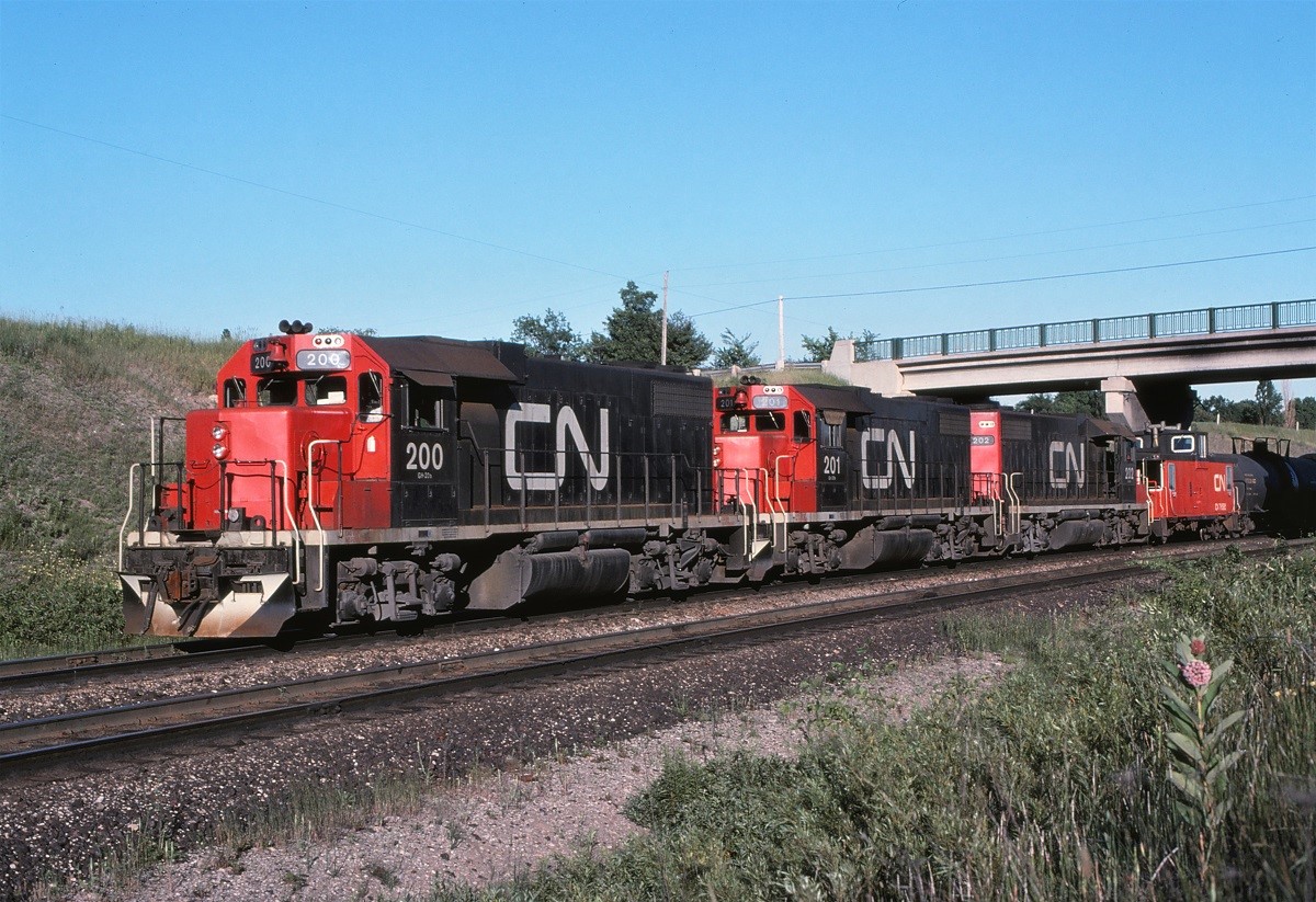 The way it used to be: (well, for a few weeks at least until the GMD yard slugs were delivered) three GP38-2s shoving cars over the hump.  6000 HP doing the work of what 2000 HP used to do. The 200 had been reconfigured to run long hood forward for its new hump yard duties.  These units were built as 5541, 5552, and 5542 in 1973.  Subsequently, they were renumbered again to 7500, 7501 and 7502.