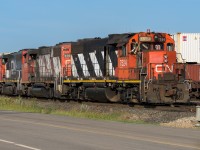 While an IM passes in the background, the 7524, 4767 and 9513, with tailend man perched and watching, shove a bunch of gondolas down to AltaSteel. Many of the yard movements I have watched, still require a person at each end. In addition, 3 on a crew is not unusual either on those instances (2 were at the front here).