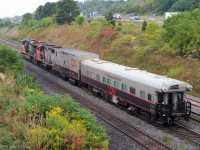 A CN TEST Track Evaluation System train was proceeding west on the Oakville Sub, beyond Aldershot Yard at 9:11 EDT on "9/11".<br>
It was heading to Hamilton and the Grimsby Sub. Odd that the mp33 detector reported 19 axles. <br><br>
The lead engine, ES44dc CN 2274 had a rectangular box on its front hood (resembling an outdoor security camera) and a dashcam-like device inside the left cab window.<br>
The modified boxcar is CN 414852 "DGRMS Test Car". The TEST Track Evaluation System coach is CN 1057. <br>
Both have CN Engineering emblems.

